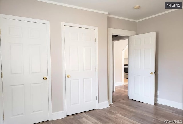 unfurnished bedroom featuring crown molding and light wood-type flooring