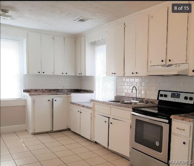 kitchen with stainless steel range with electric stovetop, sink, a textured ceiling, and white cabinets