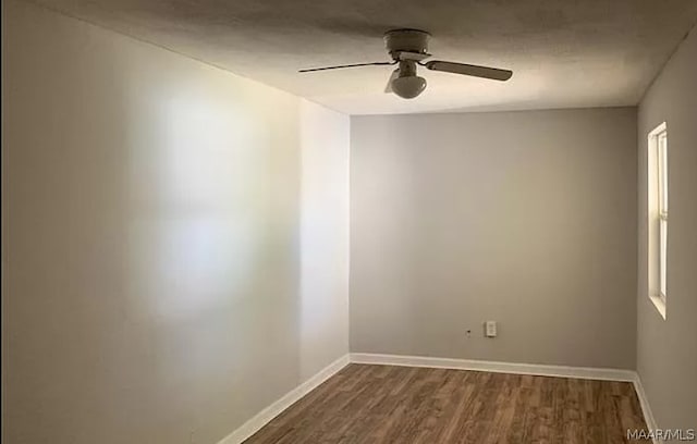 spare room featuring wood-type flooring and ceiling fan