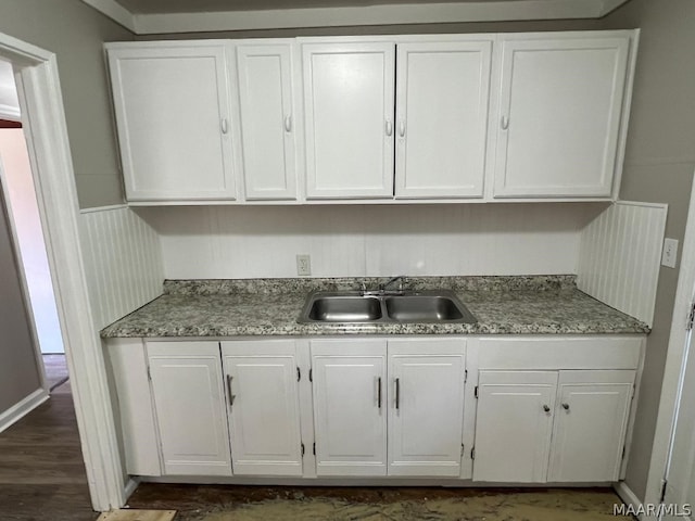 kitchen with sink, white cabinets, and dark wood-type flooring