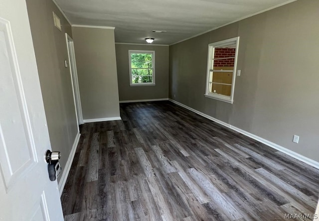 spare room with crown molding and hardwood / wood-style flooring