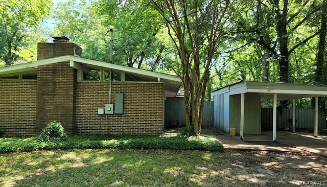 rear view of property featuring a carport