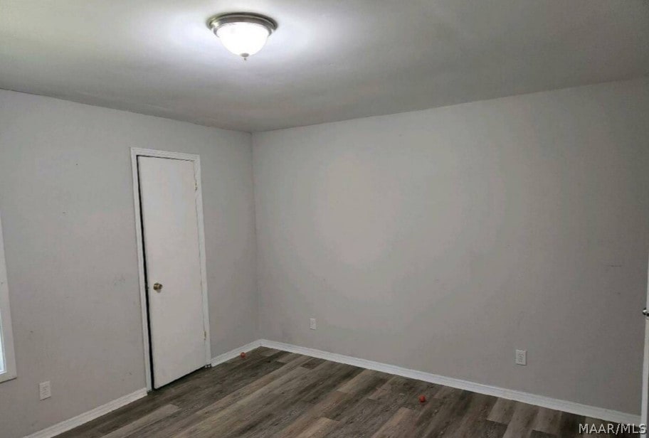 unfurnished room with hardwood / wood-style flooring