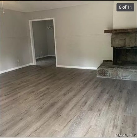 unfurnished living room featuring a fireplace and hardwood / wood-style flooring