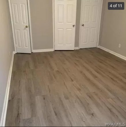 unfurnished bedroom with wood-type flooring