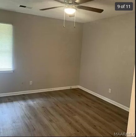 unfurnished room featuring ceiling fan and dark hardwood / wood-style flooring