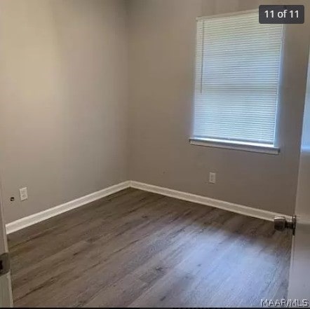 spare room with dark hardwood / wood-style floors