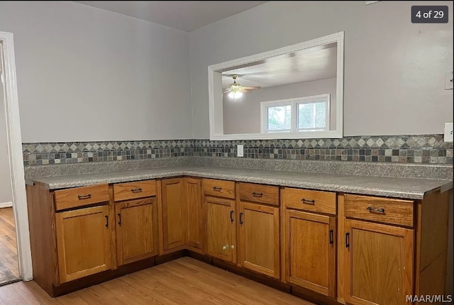 kitchen with backsplash, light hardwood / wood-style floors, and ceiling fan