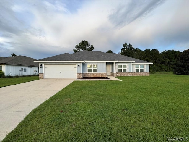 119 Cottage Ln, Atmore, AL 36502 - view of front of house with a front yard, stone siding, an attached garage, a shingled roof, and driveway