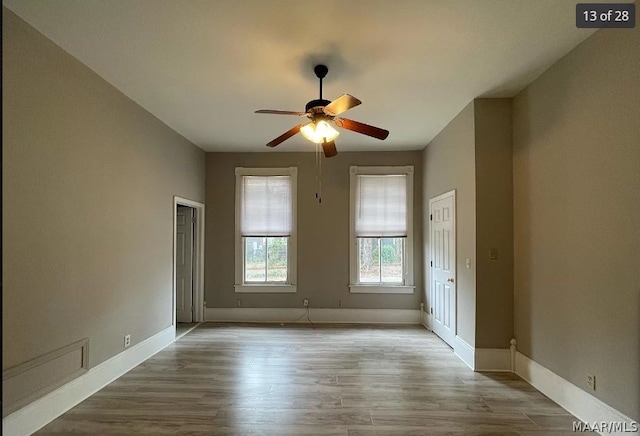 spare room featuring wood-type flooring and ceiling fan