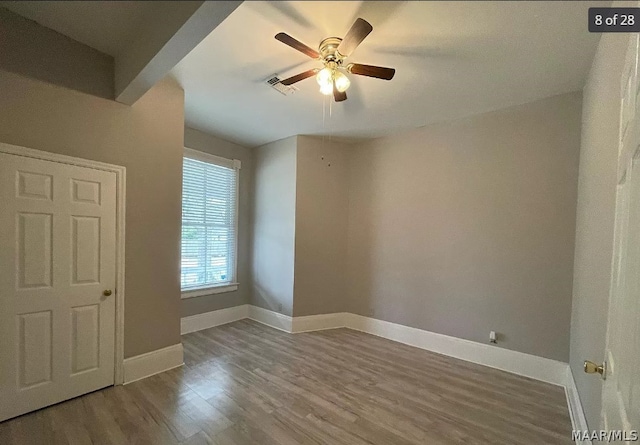 empty room with ceiling fan and hardwood / wood-style floors