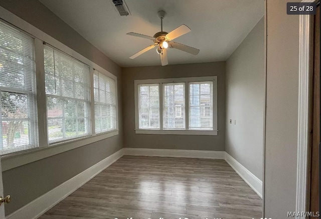 spare room featuring hardwood / wood-style flooring and ceiling fan