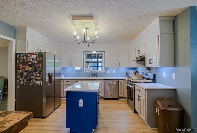 kitchen featuring white cabinetry, a center island, light hardwood / wood-style flooring, and appliances with stainless steel finishes