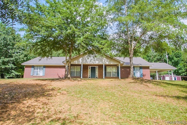 ranch-style home with a front yard and a carport