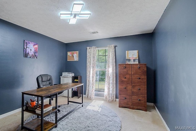 home office with light carpet and a textured ceiling