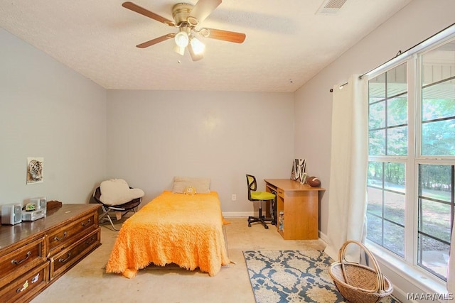 bedroom featuring a textured ceiling and ceiling fan