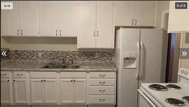 3308 Harrison Rd, Montgomery, AL 36109 - kitchen featuring white appliances, a sink, white cabinets, and light countertops