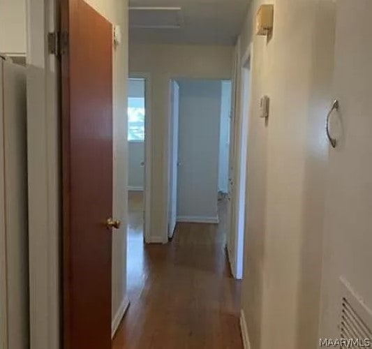 hallway with hardwood / wood-style flooring