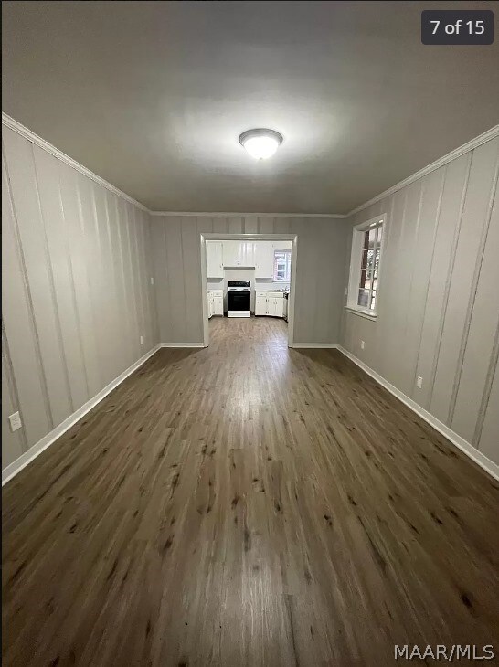3732 Honeysuckle Rd, Montgomery, AL 36109 - unfurnished living room with dark wood finished floors, a fireplace, crown molding, baseboards, and a decorative wall