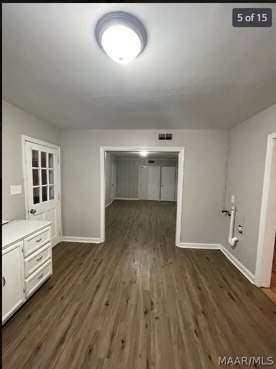 3732 Honeysuckle Rd, Montgomery, AL 36109 - unfurnished living room with dark wood-style floors and baseboards