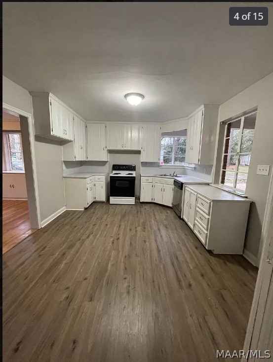 kitchen featuring white cabinetry, white range, dark wood-type flooring, dishwasher, and sink