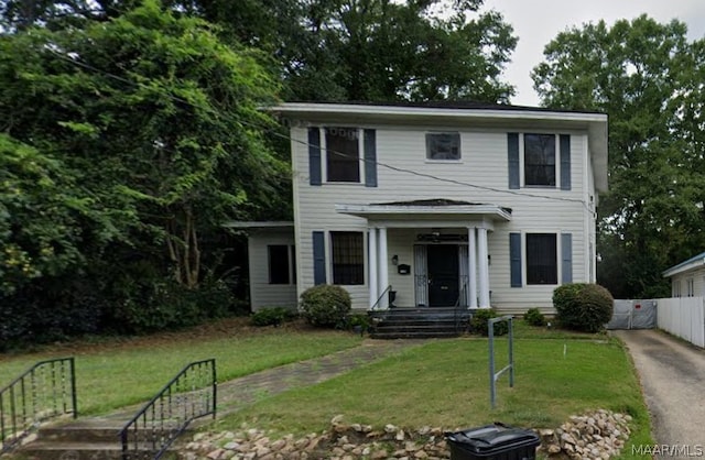 colonial-style house with a front lawn