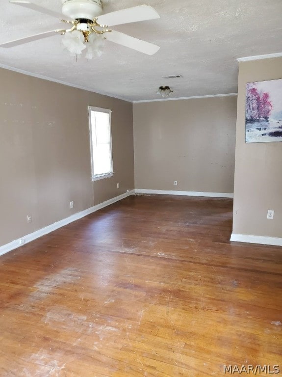 spare room with crown molding, ceiling fan, and hardwood / wood-style floors