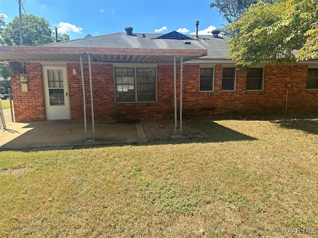 back of property featuring a lawn and a patio area