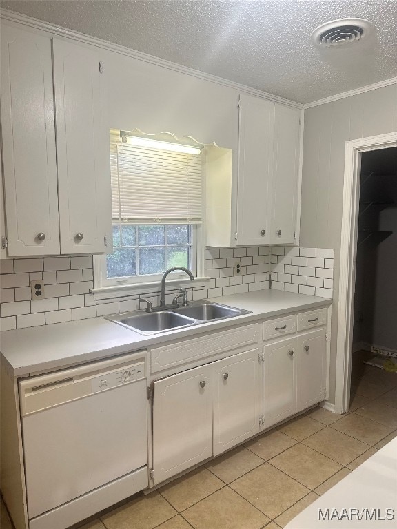 kitchen with light tile patterned floors, white cabinetry, sink, and white dishwasher