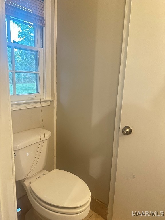 bathroom with toilet and tile patterned floors