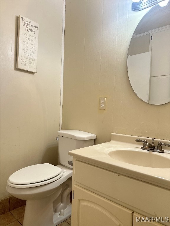 bathroom featuring vanity, toilet, and tile patterned floors