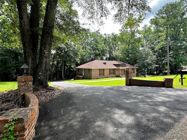 ranch-style home with a front lawn