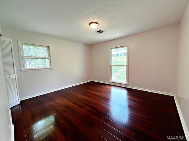 unfurnished room with dark hardwood / wood-style floors