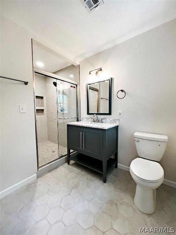 bathroom with vanity, toilet, and walk in shower