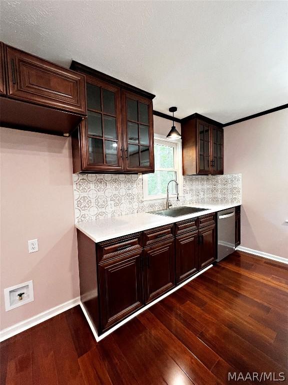 kitchen featuring dark hardwood / wood-style floors, decorative light fixtures, sink, decorative backsplash, and stainless steel dishwasher