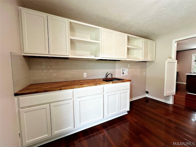 kitchen featuring white cabinetry, dark hardwood / wood-style flooring, and wood counters