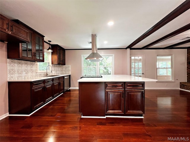 kitchen featuring sink, dark brown cabinetry, tasteful backsplash, a kitchen island, and stainless steel dishwasher