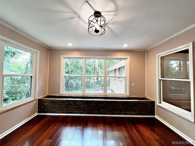 interior space with dark wood-type flooring and ornamental molding