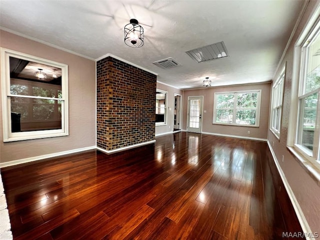 unfurnished living room with hardwood / wood-style floors and ornamental molding