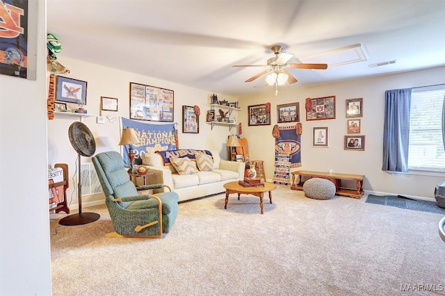 living room with ceiling fan and carpet