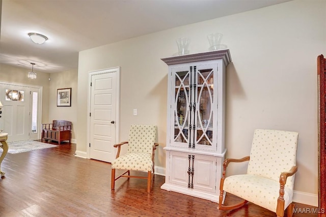 sitting room with dark hardwood / wood-style flooring