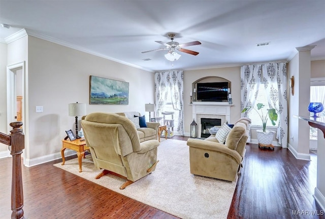 living room with ornamental molding, dark hardwood / wood-style floors, and ceiling fan