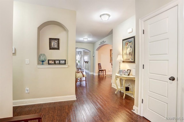 corridor with dark hardwood / wood-style floors