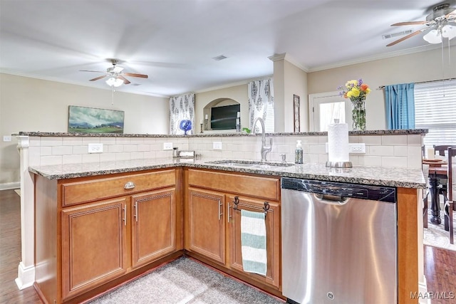 kitchen featuring crown molding, sink, backsplash, and stainless steel dishwasher