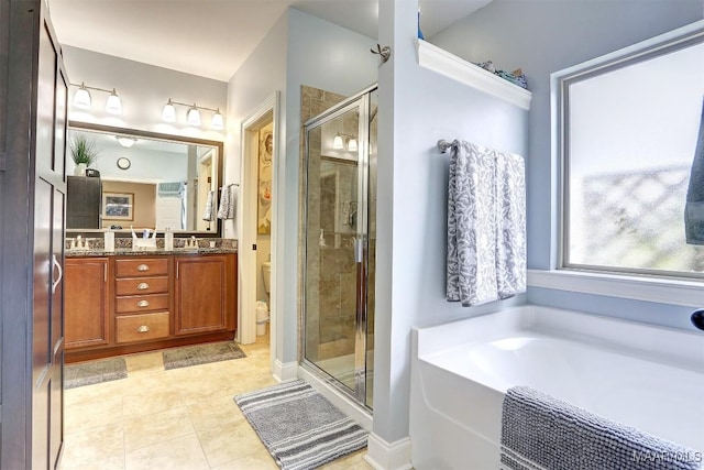 full bathroom featuring toilet, vanity, shower with separate bathtub, and tile patterned flooring