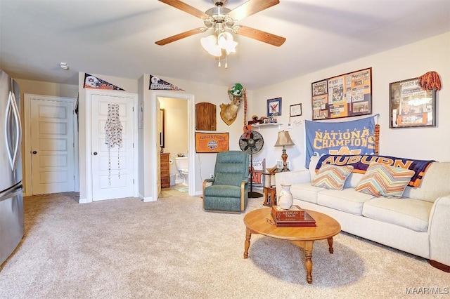 carpeted living room with ceiling fan