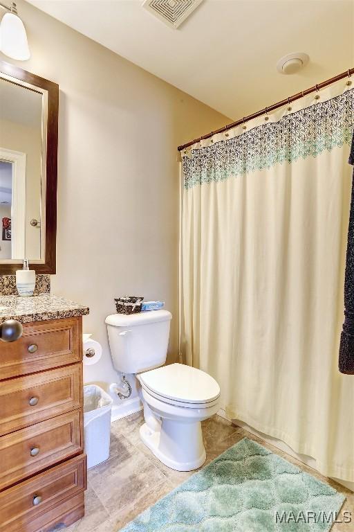 bathroom with vanity, a shower with shower curtain, tile patterned floors, and toilet