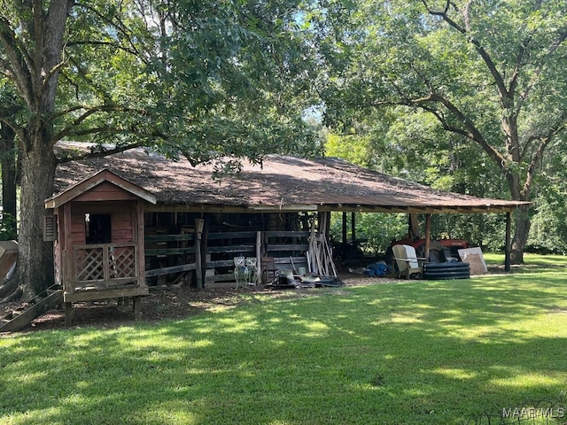 exterior space with an outdoor structure and a front yard