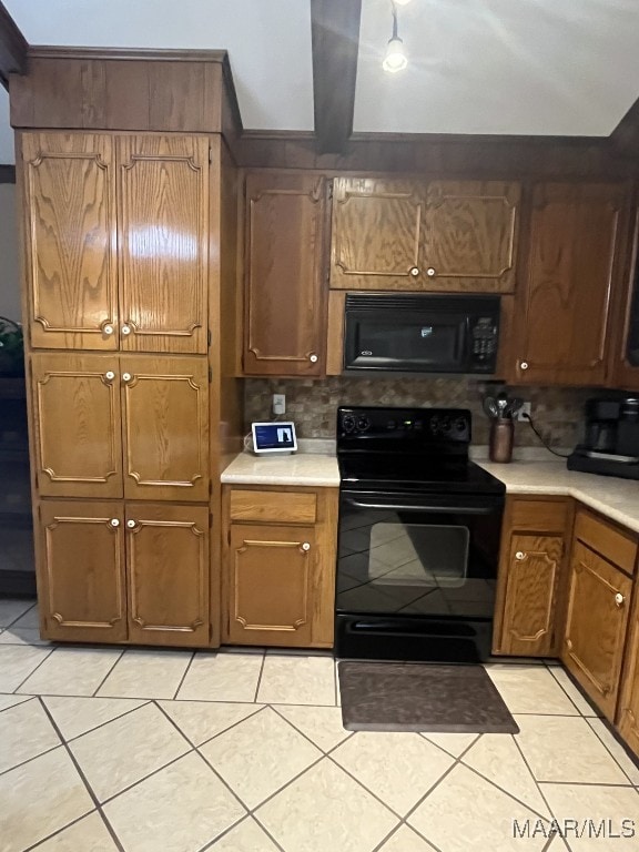 kitchen featuring light tile patterned flooring, black appliances, and backsplash