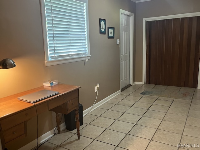 unfurnished office with light tile patterned flooring and ornamental molding